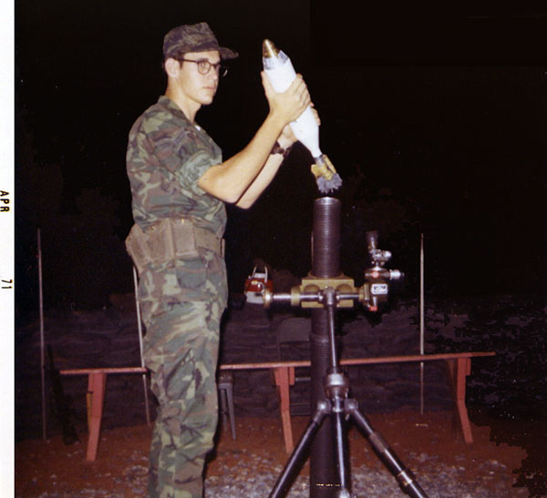 6. NKP RTAFB: 81mm -- Hangin The Tube. Photo by Wilfred Wright. 1971.