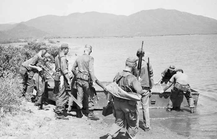 Photo #1 (Nha Trang): This is a shot of several of us getting ready to cross the river in order to get to the firing range. I am the tall one wearing the Ridgeway Hat with back to camera. I remember that me and another AP had to swim the river to retrieve the boat. While we were firing, someone had returned to boat to the pier, leaving us stranded. The two APs pictured holding the rear of the boat are; facing and in tiger stripes, Ken Kirchner and the AP with his back to the camera is Earl Mercer.