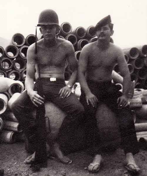 Photo #3 (Nha Trang): This was taken behind the hooches prior to moving into the new concrete barracks. Pictured with me (on left) is A2C Earl Mercer, who lived in the same hooch as I did.
