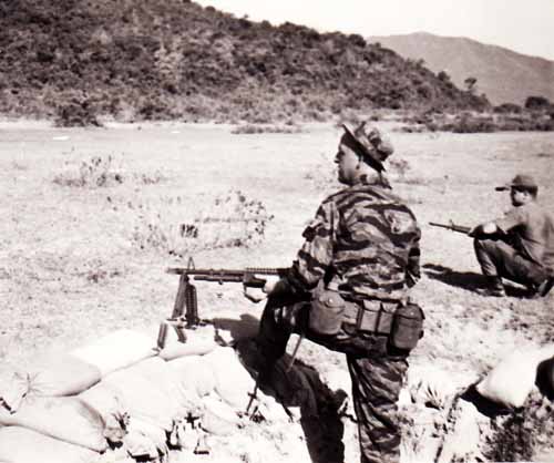 Photo #7 (Nha Trang): Another shot while at the firing range. The AP on the M60 is unknown. Standing is SSgt Roger Rude, NCOIC of the Armory.