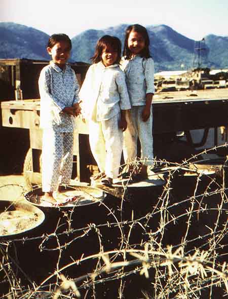 4. Nha Trang Air Base: Children playing on barrels, trailers, and containers. Photo by Phil Lange, 1968-1969. 