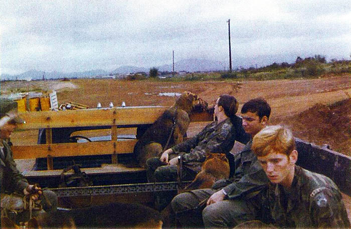 13. Posting truck, right side, front of truck to tailgate back: __________, 
middle Airman is Chuck Helms, with Eric # 2A57, and William M. (Mike) Adcock with K-9 Tiny A653.