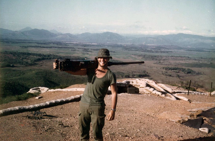 14. Phu Cat Air Base: Post 151, Doug Davis, K-9, carries Big Gun .50 Cal on post. Phu Cat AB in background-cente. Photo by: Doug D. Davis, 1968.