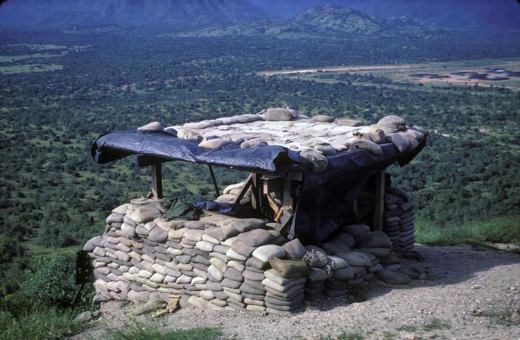 3. Phan Rang Air Base: OP-2, a bunker fortified with PSP and sandbags, armed with an 50.cal machinegun, overlooks the valley below and the bomb dump (right).