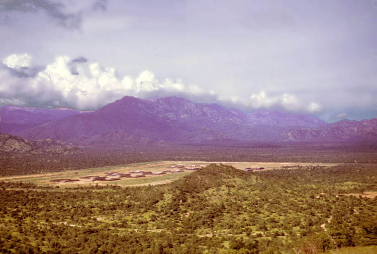 5. Phan Rang AB (early 1966): Bomb Dump nestled between rolling hills and scrub tree covered mounds. 