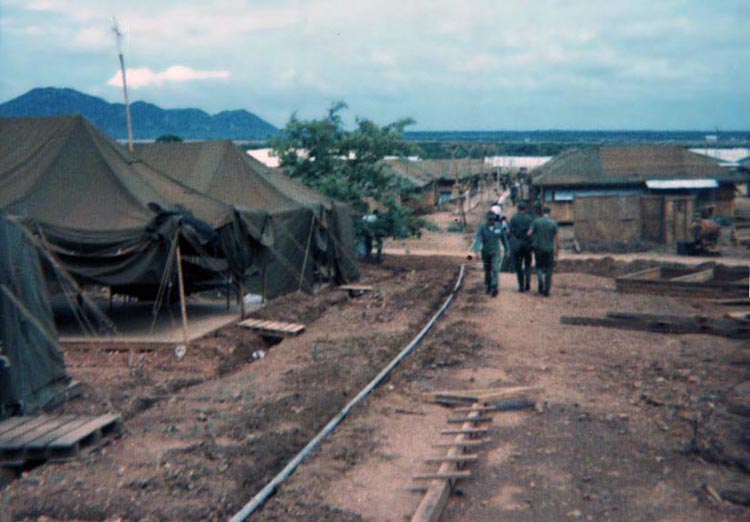 12. Phan Rang Air Base: 366th APS walk trails of baked clay or muddy-quagmire before wooden-pallet walkways are built.