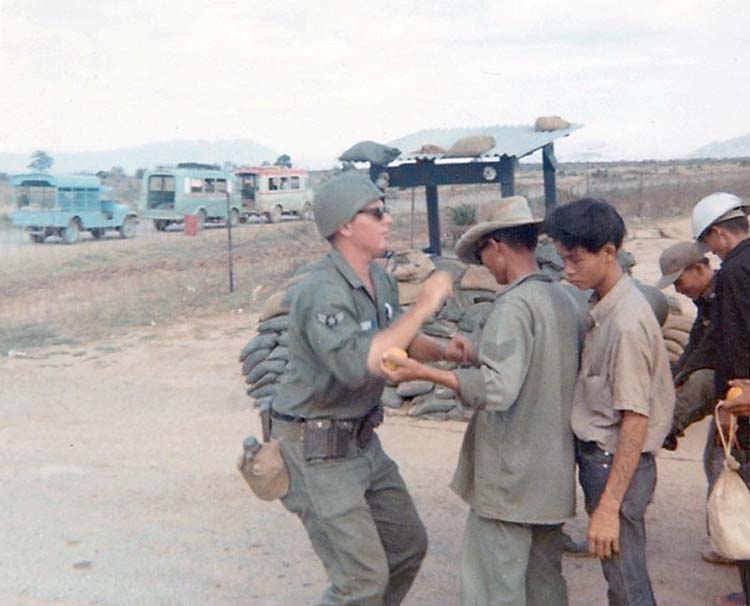 2. Phan Rang Air Base: Searching Vietnamese workers going home from bomb dump. Photo by: Van Digby, 1967-1968