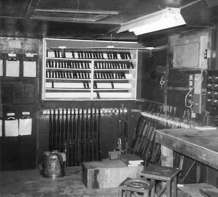 22. Phan Rang Air Base: Law and Security Weapons Room. Handguns, Shotguns and Weapons racks. Photo by: Van Digby, 1968.