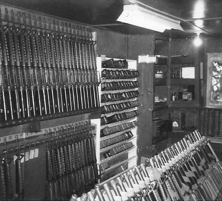 23. Phan Rang Air Base: Law and Security Weapons Room: M-16 Weapons, Radio and battery chargers racks. Photo by: Van Digby, 1968.