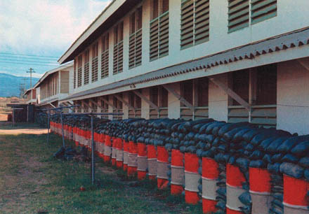 51. Phan Rang AB: Sandbags and sand-filled barrels provide shrapnel barrier for first floor bunks.