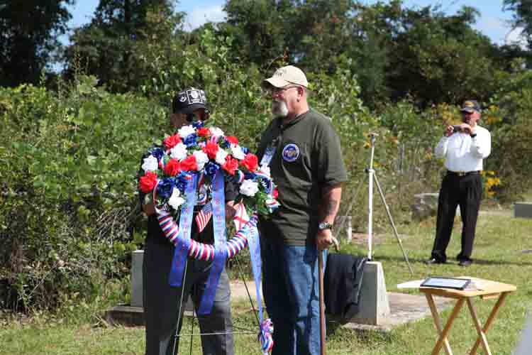 (76) Don Poss directs the order of Memorial procession to Sgt Bruce Dale Jones' nearby gravesite. Jim Willis, VSPA LM 78, Director of Veteran's Affairs for the State of Oregon, has the honor to carry the floral wreath for Ed Daubert, VSPA LM 507, 377th SPS, Tan Son Nhut. Ed served with Sgt Jones.