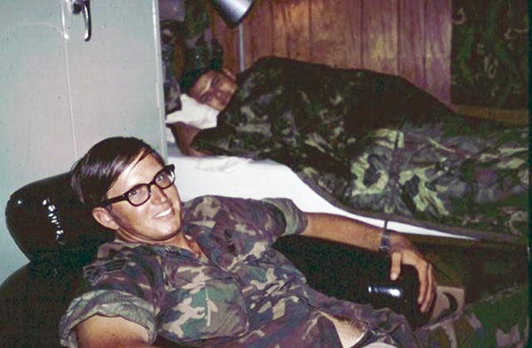 29. Yours truly, Jim Burke, in the foreground and SSgt Gabe Garcia on the bed. That was our room in Tan My. Notice the panelling on the walls! There were two of us per room and two rooms per trailer.
