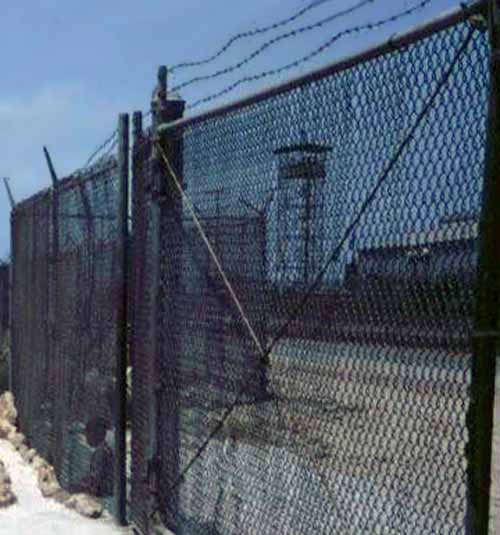 6. Cam Ranh Bay AB, Gate. A better view of the Tower through the sliding-gate. Did you spot the small boy outside the fence near the gate? Photographer: unknown.