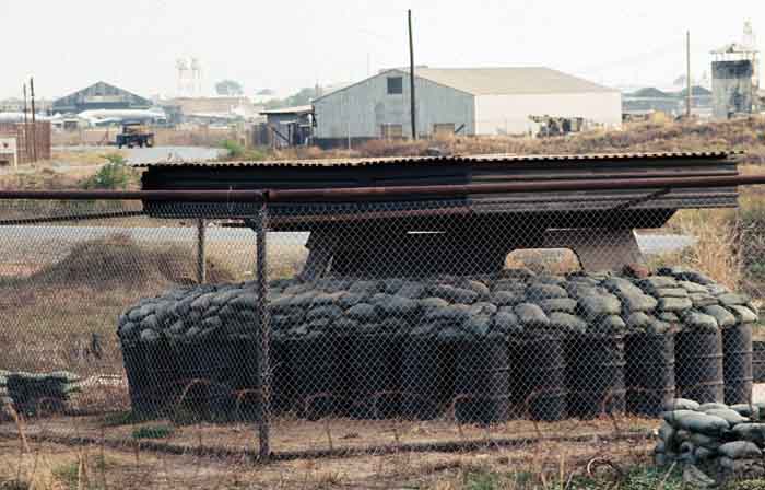 22. Tan Son Nhut Air Base: Bunker BB7: T-16 showing the fenceline to the rear/right with Bravo bunker 8 in the rear, the two story one with the pointed roof. Towers in background.