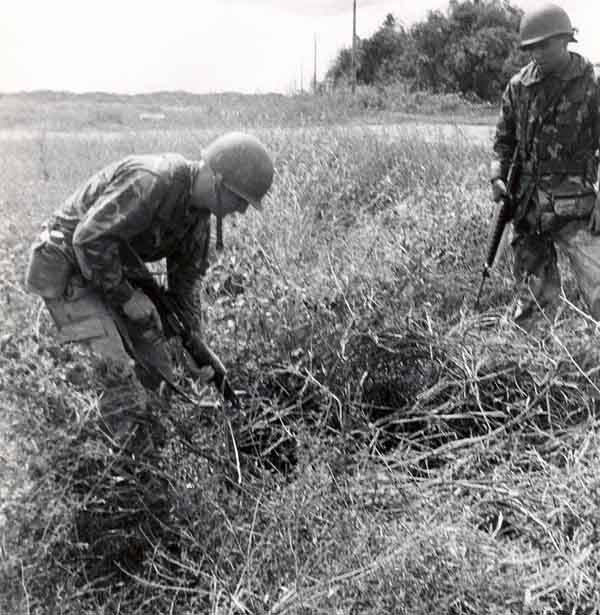 3. 377th APS Airmen search scrub brush and holes for VC and NVA sappers. 600th Photo Squadron, Vietnam.