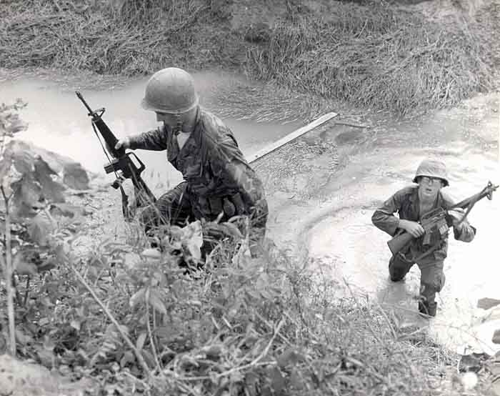 6. 377th APS Airmen crossing a gulley stream, searching for VC and NVA sappers. 600th Photo Squadron, Vietnam.