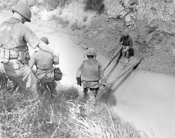 5. 377th APS Airmen crossing a gulley stream, searching for VC and NVA sappers. 600th Photo Squadron, Vietnam.