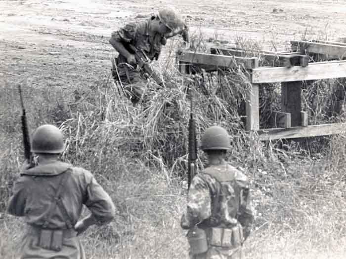 7. 377th APS Airmen search scrub brush, concealing-structures, and holes for VC and NVA sappers. 600th Photo Squadron, Vietnam.