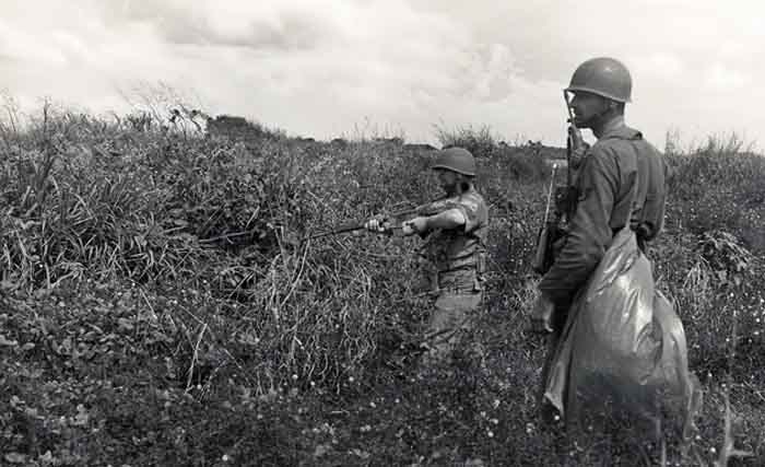 10. 377th APS Airmen search scrub brush and holes for VC and NVA sappers. 600th Photo Squadron, Vietnam.