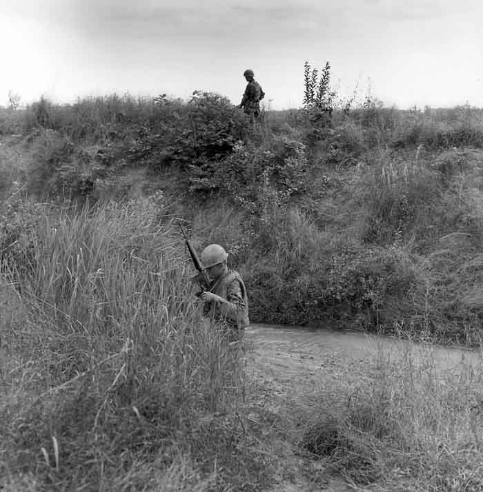 11. Photo above: 377th APS Airmen prepare to cross another stream, searching for VC and NVA sappers. 600th Photo Squadron, Vietnam.