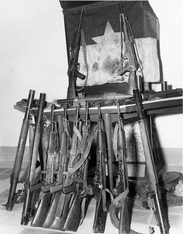 16. Photo right: VC/NVA weapons cache displayed. 600th Photo Squadron, Vietnam.