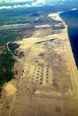 10) On the same mission just from a much higher altitude. The Pedro is south of the base and we are looking back towards the north. The area at the bottom of the photograph is the bomb dump and the runways are at the top. You can also clearly see the perimeter road along which many security positions, bunkers and towers were situated.