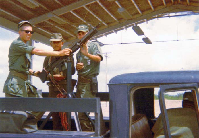 3. U-Tapao RTAFB, SAT truck with M60. 1968. Photo by: L/R: William Bever, Thai Guard, unknown Airman, 1968.